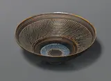 Conical bowl by Lucie Rie, circa 1965, porcelain with manganese, and blue glaze, sold Apr 2015