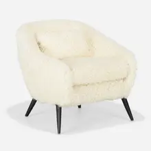 Lounge chair by Modern, c. 1955, shearling, lacquered wood, sold Feb 2023