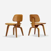 DCWs, pair by Charles and Ray Eames, ash plywood, rubber, sold Feb 2023