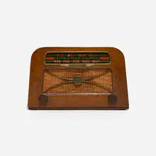 Radio, model A309 by Charles and Ray Eames, c. 1946, combed oak, plastic, Bakelite, brass, silk, sold Feb 2023