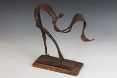 Robert Edward Kuhn, Figure Unfurling Rug, Bronze with rust and bronzed patina