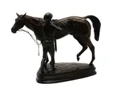Priscilla Hann, Untitled, Priscilla Hann (b. 1943). a bronze figure of a jockey saddling a horse, on a mahogany base
