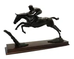 Priscilla Hann, Untitled, Priscilla Hann (b. 1943) a bronze figure of a jockey and racehorse jumping a fence, on a rectangular mahogany base