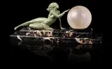 Fayral (pseudonym, for Pierre Le Faguays), circa 1925, cast as a naked maiden reclining on stepped marble base with light fitment and large globular glass shade
