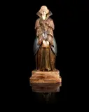 'After Reading' a Patinated Bronze and Carved Ivory Study by Demetre Chiparus, circa 1925, modelled as a maiden in elaborate costume, clasping a book in both hands, on stepped marble base, sold Jun 2014