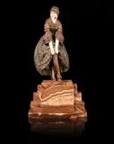 'A Slight Accident' a Patinated Bronze and Carved Ivory Study by Demetre Chiparus, circa 1925, modelled as a young woman adjusting her stocking top, on stepped marble base, sold Jun 2014