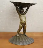 German School, A Putti Holding a Shell, Bronze statue