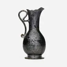 Tall pitcher by George E. Ohr, 1897-1900, glazed earthenware, sold May 2025