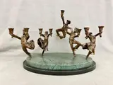Figural Menorah Cast As Five Male Dancers Celebrating Festival of Light by Zachary Oxman Figural Bronze Menorah, Oval green marble plinth base, sold Aug 2024