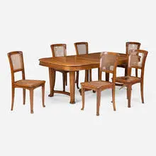 attribution Edouard Diot, Dining table and six chairs, c. 1900, mahogany, cane