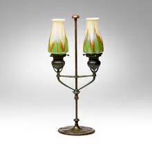Adjustable two-arm candelabrum by Tiffany Studios, c. 1910, hand-blown Favrile glass, patinated bronze, sold Apr 2025