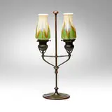 Adjustable two-arm candelabrum by Tiffany Studios, c. 1910, hand-blown Favrile glass, patinated bronze, sold Apr 2025