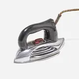 Petipoint iron, model W410 by Clifford Brooks Stevens and Edward P. Schreyer, 1941, chrome-plated steel, steel, Bakelite, fiber-wrapped cord, sold Feb 2022