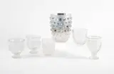 Gruppe aus sechs Vasen mit verschiedenen Formen und Motiven by René Lalique, Farbloses Glas, 1x silberfoliert innen, sold Jan 2025