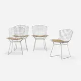 Dining chairs, set of four by Harry Bertoia, chrome-plated steel, upholstery, sold Sep 2021
