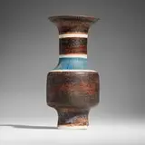 Bottle vase by Lucie Rie, c. 1979, glazed porcelain with sgraffito decoration, sold Feb 2025