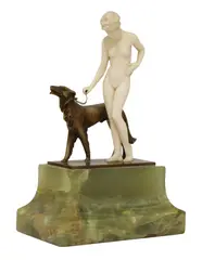 Ferdinand Preiss (German by Ferdinand Preiss, 1882, an ivory and cold-painted bronze figure of a girl with a borzoi dog, sold Oct 2021
