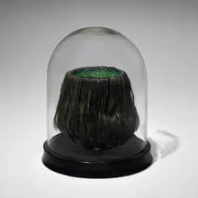 Kappa Scalp by Mike Kelley, 1985, mixed media and toupée, wine glass, glass dome, painted wood, sold Jan 2025