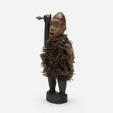 Kongo artist, Bakongo Nkisi n’kondi (power figure), carved wood, steel, rock, bone, mirrored glass, shells, rattan