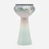 Vellum pedestal vase with apple blossoms by Edward T. Hurley for Rookwood Pottery, 1911, glazed earthenware, sold Nov 2022