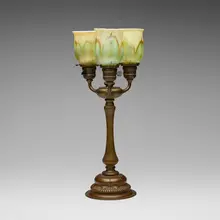 Three-light table lamp by Tiffany Studios, c. 1910, patinated bronze, hand-blown Favrile glass, sold Oct 2024