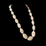 Carved Bracelet, Untitled, The bracelet features roses carved in a whitecolored material. <br><br> Weighs 82.0 grams.