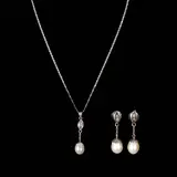 Untitled by A Set of Pearl Jewelry in 14k, The set comprises of dangling earrings and a necklace in 14k white gold accented by pear-shaped pearls and baguette diam, offered Apr 2026