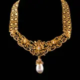 Untitled by An Intricate Flat-fold Tamburin Necklace in 14k and 18k, The tamburin necklace features intricate filigree details and a floral motif. A detacheable pearl pendant suspends from , offered Apr 2026