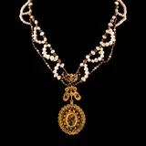 Untitled by A Pearl Tamburin Necklace in 10k and 14k, The tamburin necklace features pearls intertwined with tamburin beads in 10k yellow gold. From the necklace suspends a r, offered Apr 2026