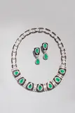 Hans Brumann, Necklace and Earrings, 18 karat white gold neck piece with 7 Colombian pe