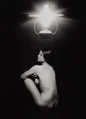 Sam Haskins, Bes seated under Lamp, 1963, photograph
