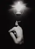 Sam Haskins, Bes seated under Lamp, 1963, photograph