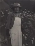 Doris Ulmann, Woman in apron with garden cosmos, 1932, photograph