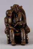 Bronskleurige figuur, opa, Bronskleurige figuur, opa met kleinzoon aan het voorlezen. gesigneerd Mat Wanders