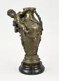 H 32 cm. by Gesigneerde bronzen vaas met putti en marmeren basement, Gesigneerde bronzen vaas met putti en marmeren basement, offered Jan 2024