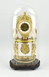 H 52 cm. by Franse vuurvergulde bronzen empire skeletklok onder stolp, offered Apr 2025