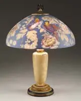 Handel, Reverse Painted Parrot Lamp, Shade rests atop a simple enameled base with three-light cluster