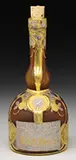 Grand Marnier Cameo Glass Bottle by Daum, All against acid textured brown glass background, offered Jun 2016