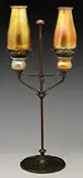 Adjustable Double Candle Lamp by Tiffany Studios, The double arms support gold favrile candle cups with bronze bobeche inserts, offered Nov 2016
