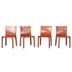 Mario Bellini, FOUR 'CAB 412' CHAIRS FOR CASSINA, Cognac saddle leather over a steel and plastic frame with a zipper system. Cassina sticker to plastic undersides