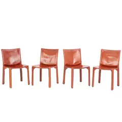 Mario Bellini, FOUR 'CAB 412' CHAIRS FOR CASSINA, Cognac saddle leather over a steel and plastic frame with a zipper system. Cassina sticker to plastic undersides