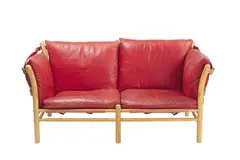 'ILONA' TWO SEAT SOFA by Arne Norell, Ruby red and tan leather with straps, sold Jul 2020