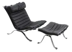 'AIR' LOUNGE CHAIR AND OTTOMAN by Arne Norell, Black leather on polished steel frame, sold Nov 2019