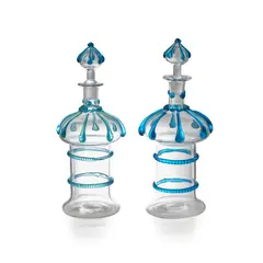James Powell & Sons, MATCHED PAIR OF DECANTERS, CIRCA 1890, 1890, clear glass with applied blue teardrop decoration, 31.5cm high