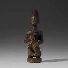 figure with dog by Yoruba, carved wood, sold Aug 2020