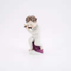 Putto mit Querflöte by Meissen, 19. Jh, Porzellan, farbig staffiert, gold dekoriert, sold May 2025