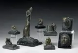 Edwin Willard Deming, A Figure Playing a Flute with a Puma at his Side; The Head of an Indian; The Head of a Puma; A Child and a Bear; A Bear Looking into a Tree Stump; Two Bears Wrestling; Two Bears Hugging; A Seated Bear with a Fish (a group of eight)