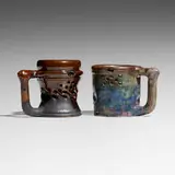 Puzzle mugs, set of two by George E. Ohr, 1895-96, glazed earthenware, sold Sep 2024