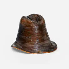 Novelty hat by George E. Ohr, 1898-1910, glazed earthenware, sold Sep 2024