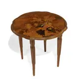 side table depicting a woodpecker perched on oak branch, retrieving an acorn by Émile Gallé, sold Apr 2022